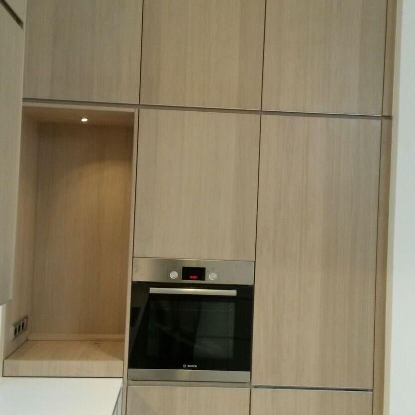 Hochschrankwand mit Einbaubackofen Küchenhochschrank mit Holzfronten, integriertem Backofen und seitlicher Nische mit Spot